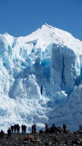 Spectacular view of tourists observing the majestic Perito Moreno Glacier in El Calafate, Argentina.